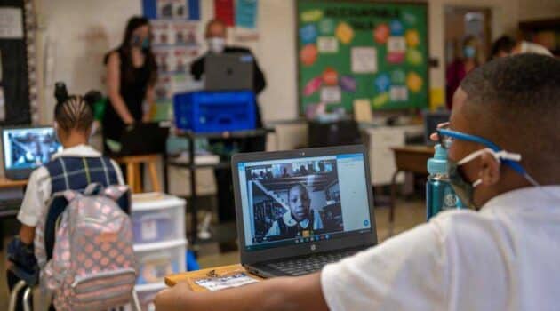 A fifth-grader at Holy Angels Catholic School connects with classmates virtually