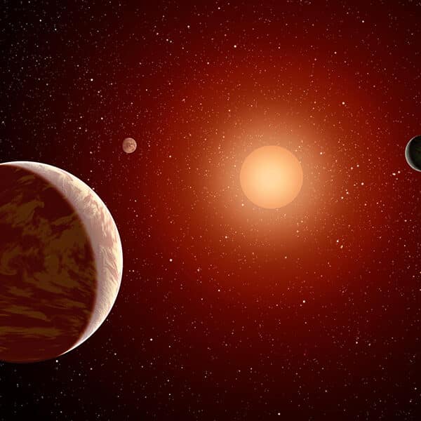 This NASA artist's concept illustrates a young, red dwarf star surrounded by three planets.