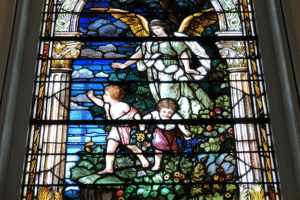 Stained glass window shows guardian angel with boy and girl