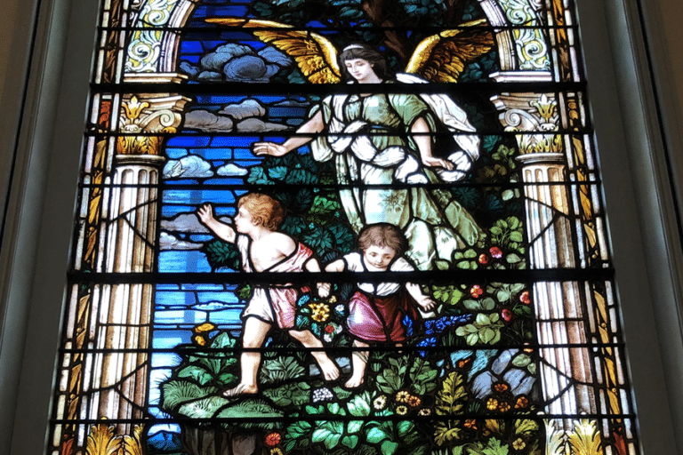 Stained glass window shows guardian angel with boy and girl
