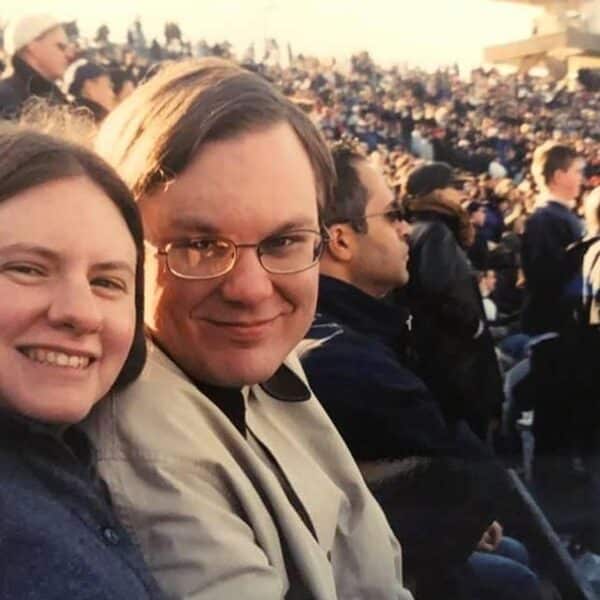 My brother-in-law and sister smiling for the camera at a football game in a stadium in New Haven Connectict