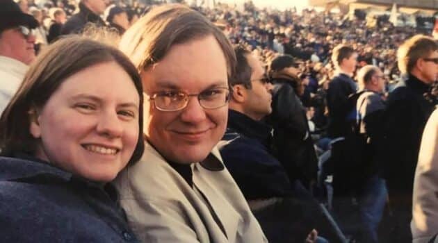 My brother-in-law and sister smiling for the camera at a football game in a stadium in New Haven Connectict