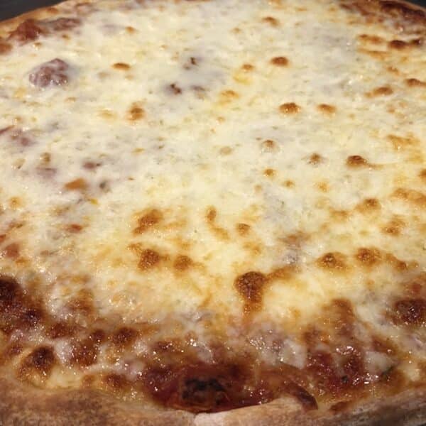 A whole cheese pizza on a pan