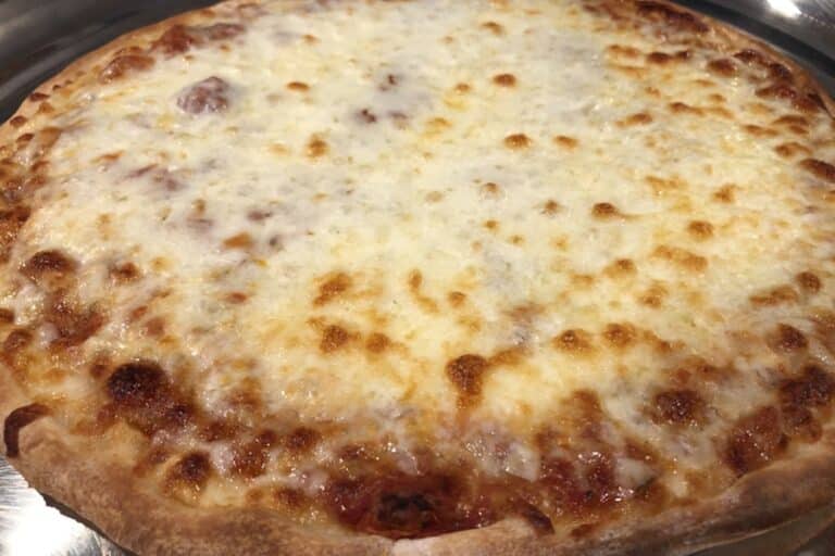 A whole cheese pizza on a pan