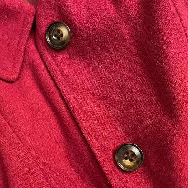 Image of two buttons on a red winter coat