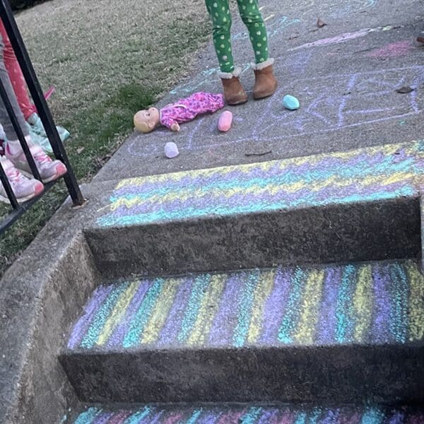 steps and a sidewalk decorated in colored chalk by children
