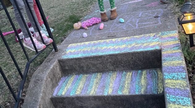 steps and a sidewalk decorated in colored chalk by children