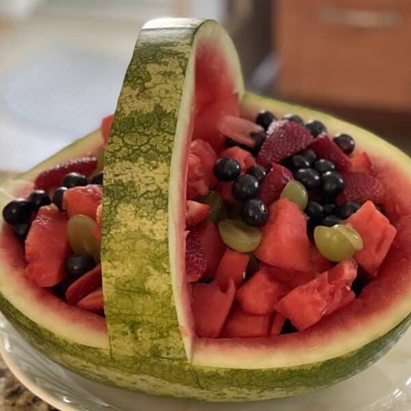 Watermelon cut into a basket and filled with fruit