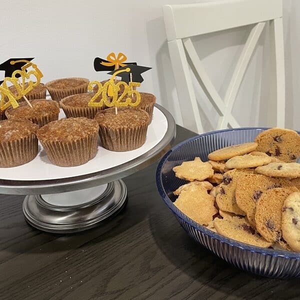 Cupcakes with 2025 graduation toothpicks in them and a bowl of cookies