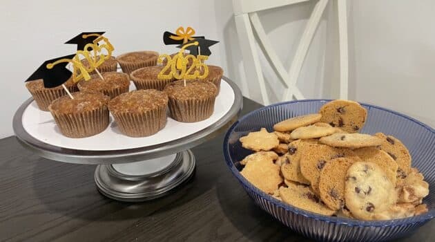 Cupcakes with 2025 graduation toothpicks in them and a bowl of cookies