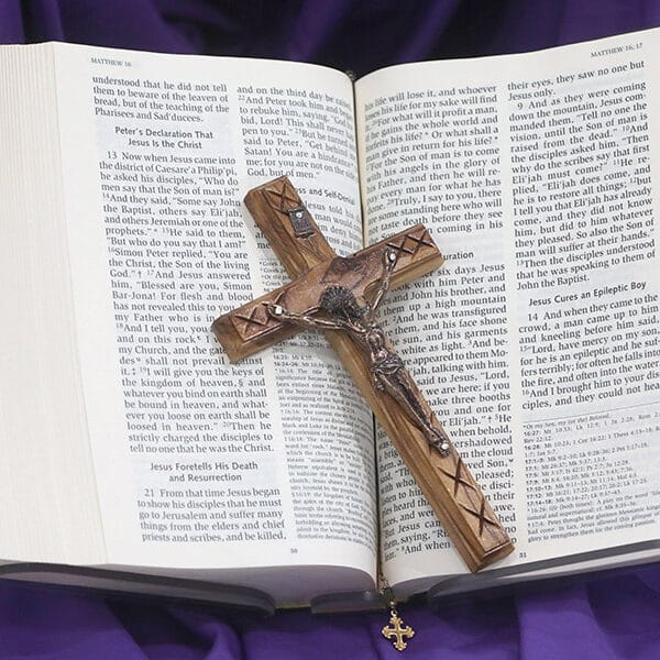 A crucifix and Bible on purple cloth