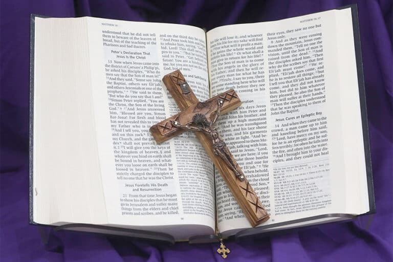 A crucifix and Bible on purple cloth