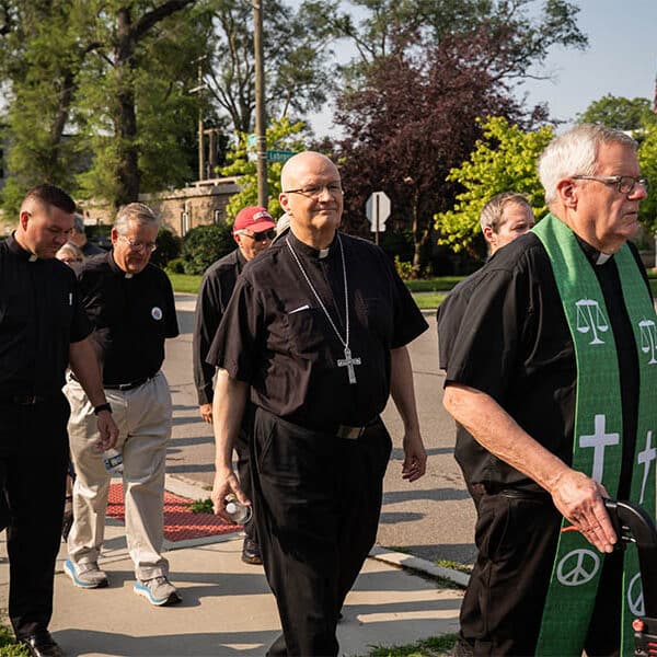 Church leaders, faithful in procession to Detroit ICE office call for just immigration policies