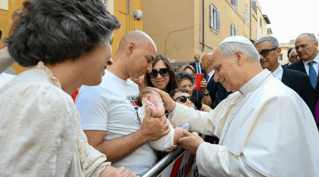 Pope Leo XIV blessing a baby
