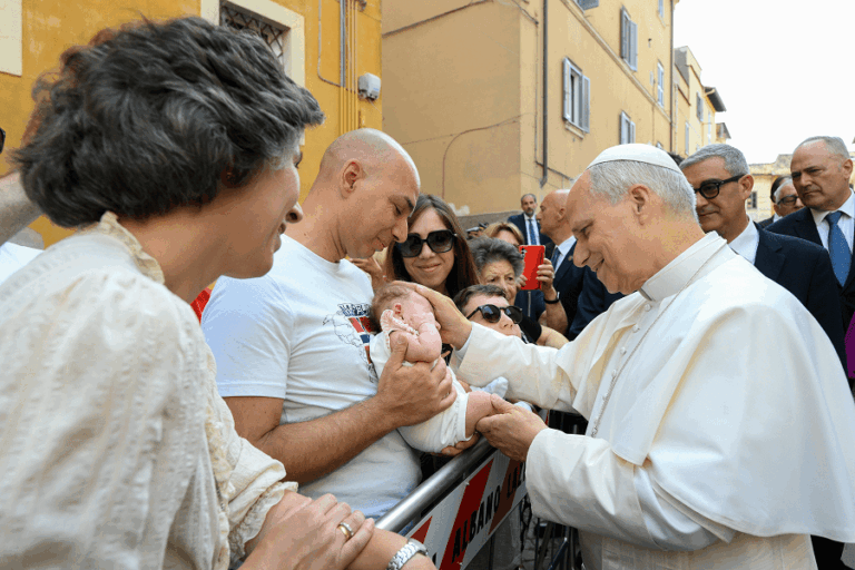 Pope Leo XIV blessing a baby