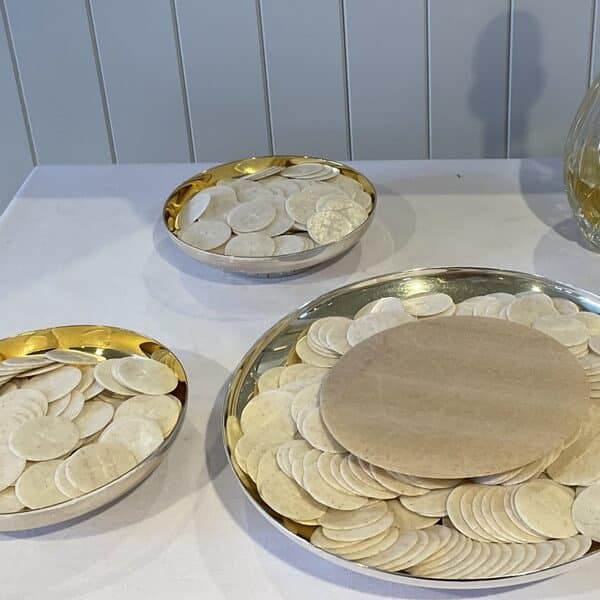 hosts sit on plates ready for communion at church