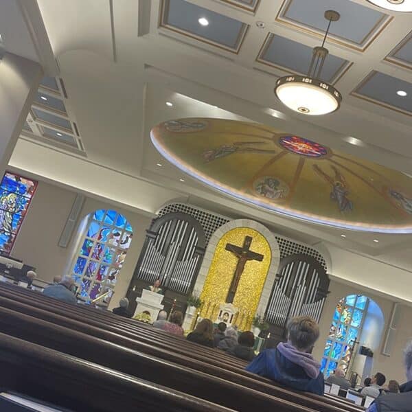 View of a church with a dome and a crucifix and pews