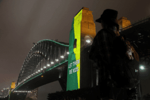 A message the reading "Let them be kids" is projected onto the Sydney Harbor Bridge