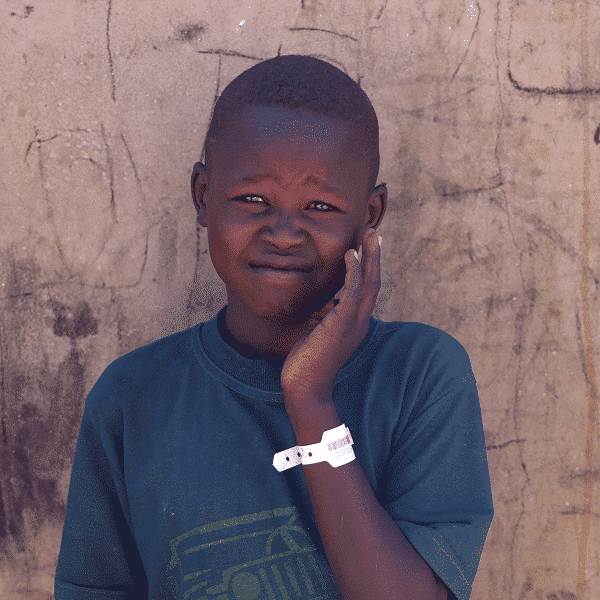Moltazem Mohamed, 10, a Sudanese refugee boy from al-Fashir, poses at the Tine transit refugee camp