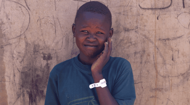 Moltazem Mohamed, 10, a Sudanese refugee boy from al-Fashir, poses at the Tine transit refugee camp