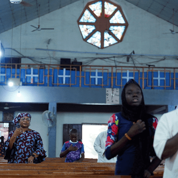 Worshippers attend an evening Mass