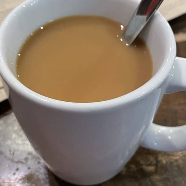White mug of coffee on a table in a restaurant