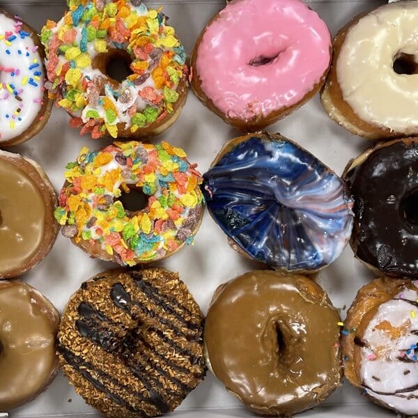 One dozen varied donuts in a box
