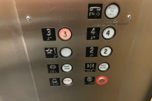 Buttons on an elevator with the 3 lit up
