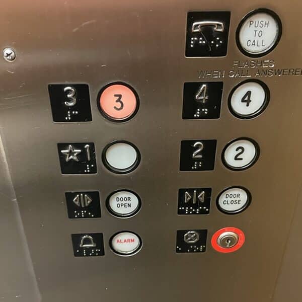 Buttons on an elevator with the 3 lit up