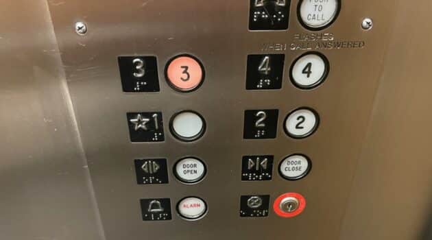 Buttons on an elevator with the 3 lit up